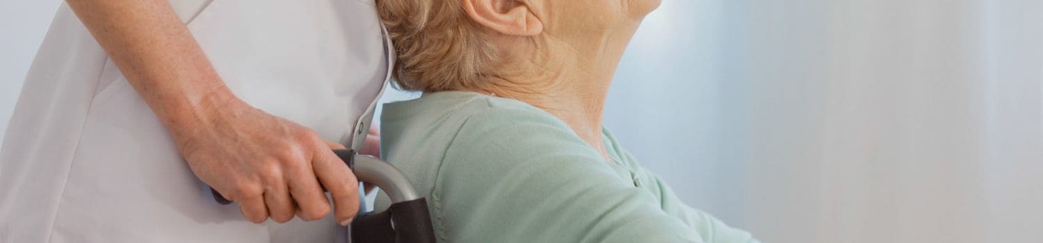 Staff taking care of elderly woman