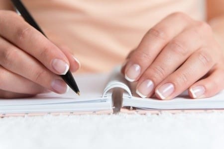 Woman writing in diary Woman writing in diary