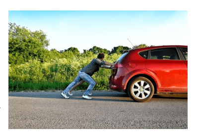 Man pushing a car Man pushing a car