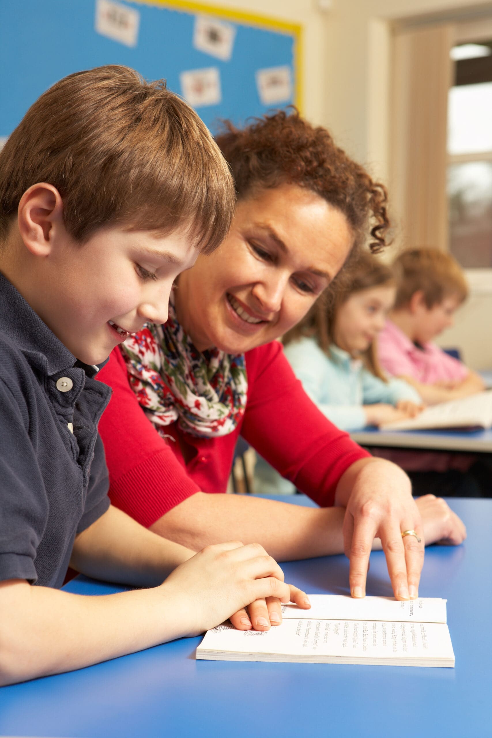 Schoolboy,Studying,In,Classroom,With,Teacher shutterstock 72372274 2 scaled